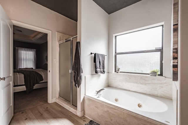 bathroom with hardwood / wood-style floors and plus walk in shower