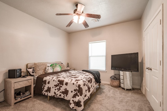 carpeted bedroom with ceiling fan