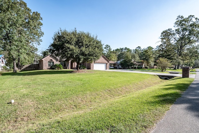 view of front of property featuring a front yard and a garage