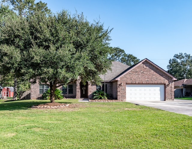 obstructed view of property with a front yard and a garage