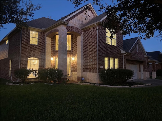 view of front of property with a front lawn and a garage