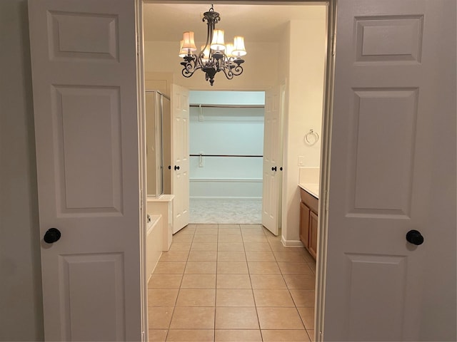 bathroom with vanity, tile patterned flooring, and a notable chandelier