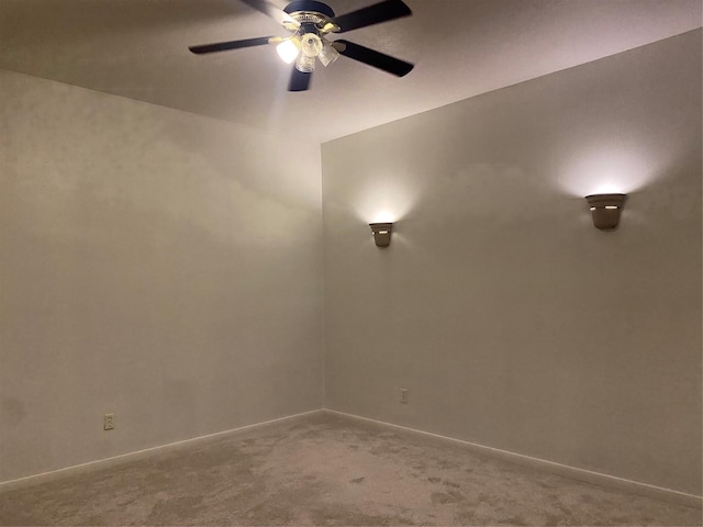 empty room featuring carpet floors and ceiling fan