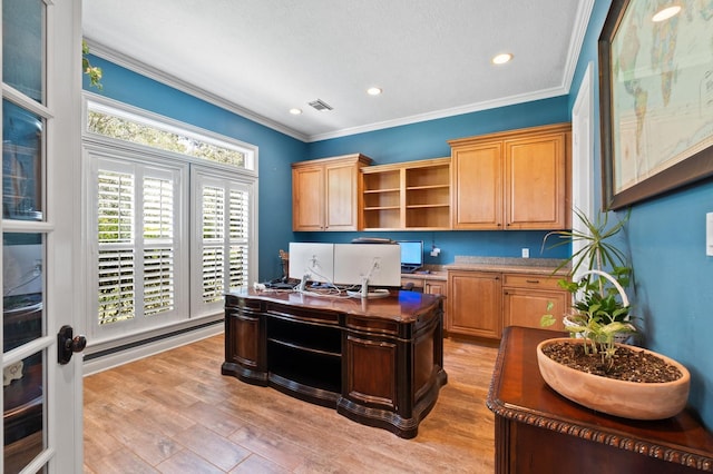 office with built in desk, light wood-type flooring, and ornamental molding