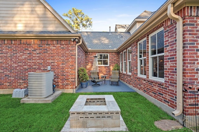 view of patio featuring central AC and an outdoor fire pit