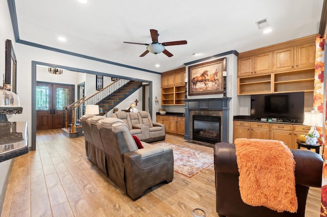 living room featuring ceiling fan, light hardwood / wood-style flooring, french doors, and crown molding