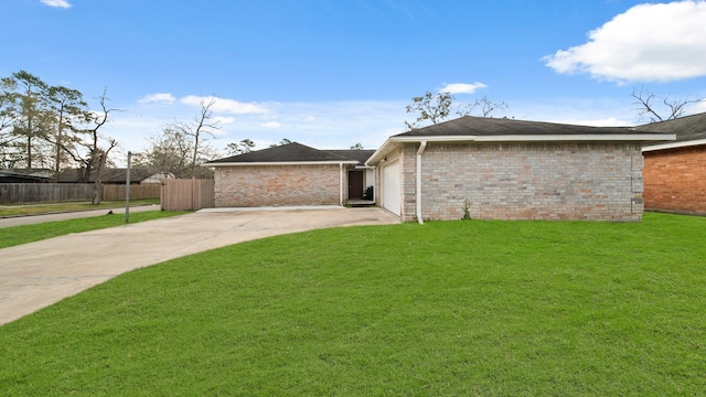 view of front of home with a front lawn and a garage