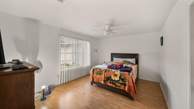 bedroom with ceiling fan and light wood-type flooring