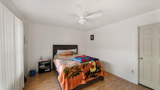 bedroom with ceiling fan and hardwood / wood-style flooring