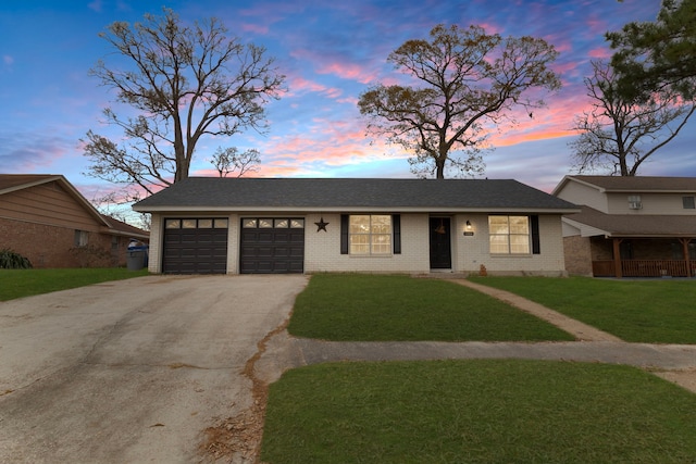 view of front facade featuring a garage and a lawn