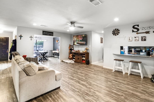 living room with ceiling fan and hardwood / wood-style floors