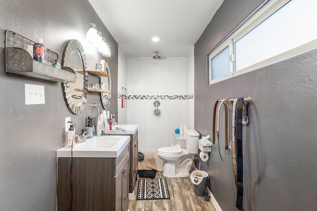 bathroom with toilet, vanity, and hardwood / wood-style flooring