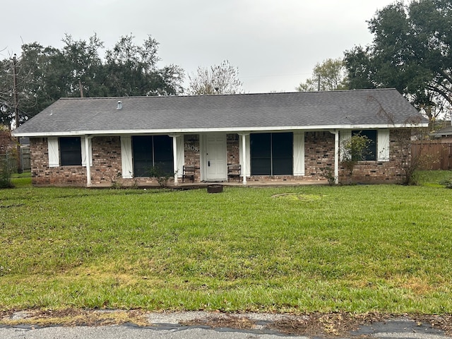 single story home with a porch and a front yard