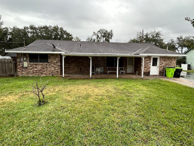 view of front of house with a patio and a front lawn