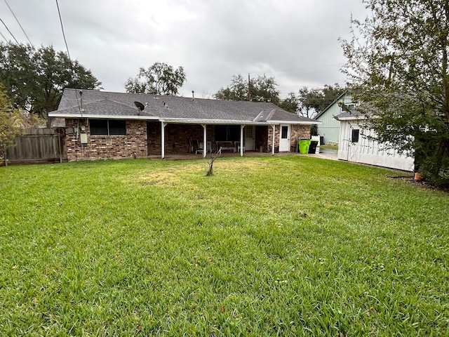 back of property with a lawn