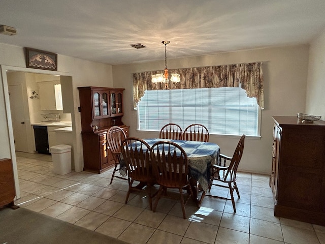 dining area featuring an inviting chandelier and light tile patterned flooring