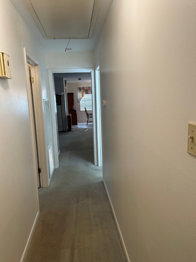 corridor featuring dark colored carpet