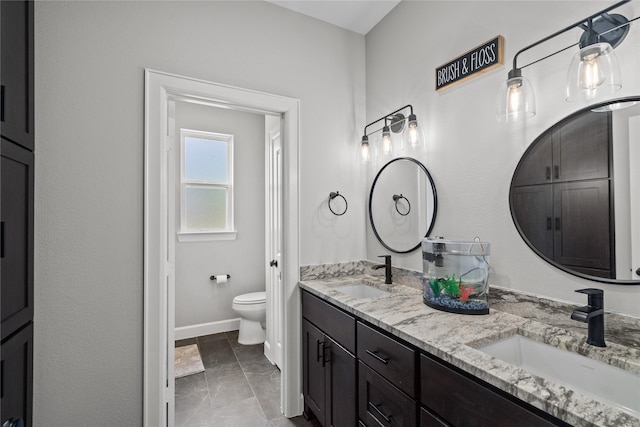 bathroom featuring tile patterned floors, vanity, and toilet