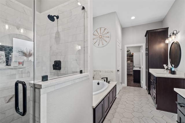 bathroom with shower with separate bathtub, vanity, and tile patterned floors