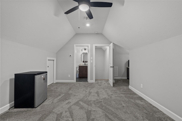 additional living space with light carpet, ceiling fan, and vaulted ceiling