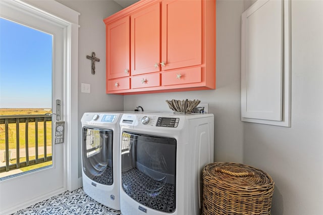 clothes washing area featuring cabinets, separate washer and dryer, and a healthy amount of sunlight