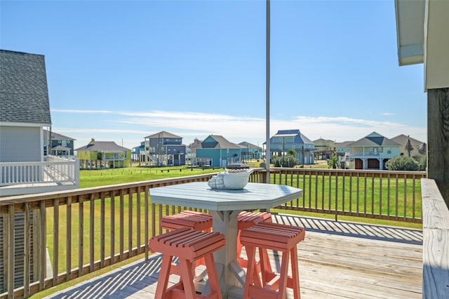 wooden deck featuring a yard