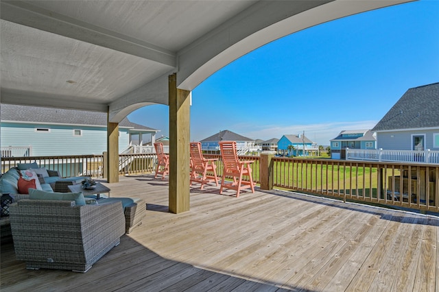 wooden deck featuring a lawn