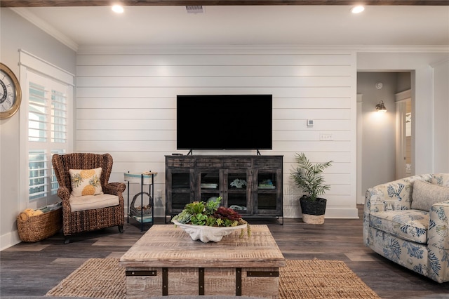 living room with wooden walls, crown molding, and dark hardwood / wood-style floors