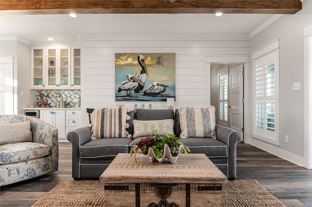 living room featuring dark wood-type flooring, wooden walls, beam ceiling, wine cooler, and ornamental molding