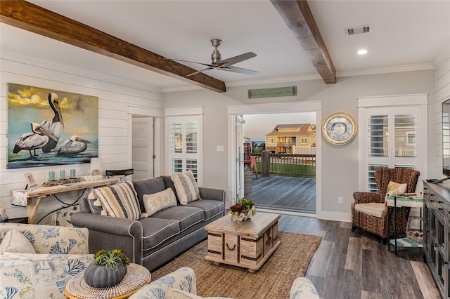 living room featuring ornamental molding, dark hardwood / wood-style flooring, ceiling fan, wooden walls, and beam ceiling