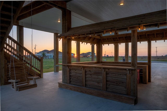 patio terrace at dusk featuring exterior bar and a gazebo