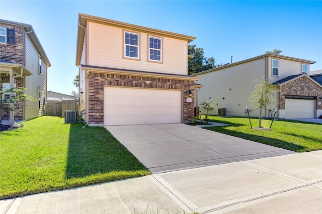 view of front property with a front lawn, central AC unit, and a garage