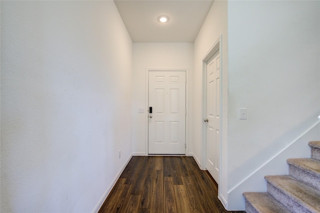 hallway with dark hardwood / wood-style floors