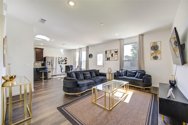 living room with dark hardwood / wood-style flooring