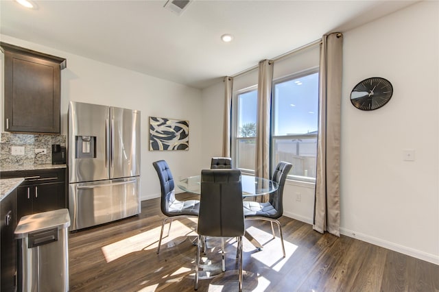 dining area featuring dark wood-type flooring