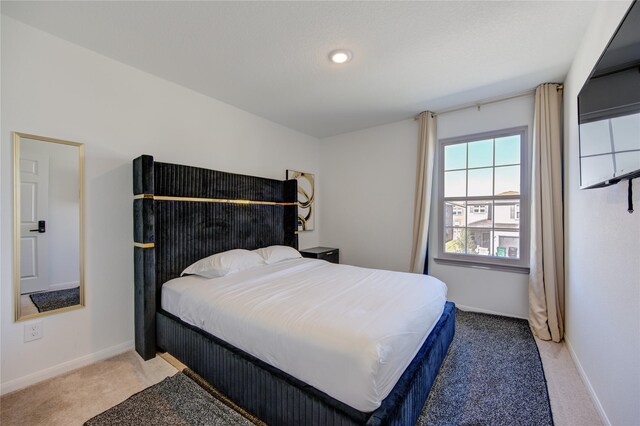 bedroom featuring light carpet