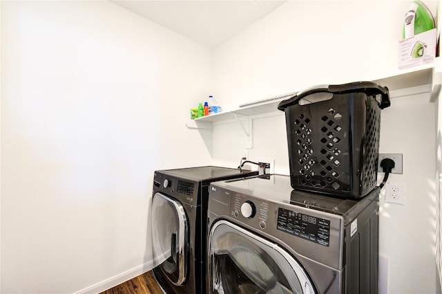 washroom featuring dark hardwood / wood-style flooring and washing machine and dryer