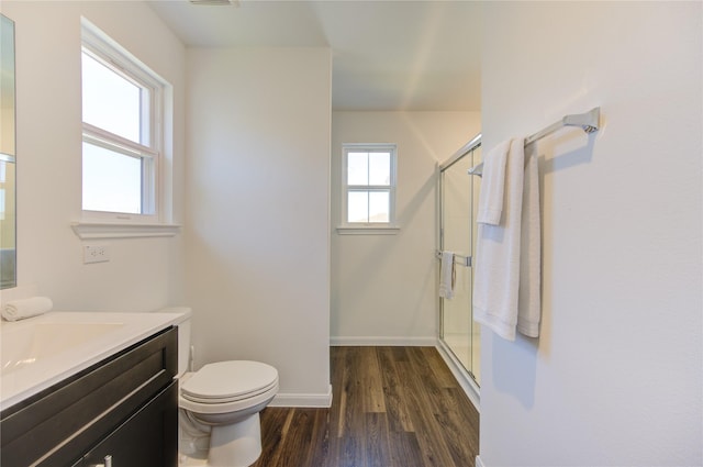 bathroom featuring walk in shower, hardwood / wood-style floors, vanity, and toilet