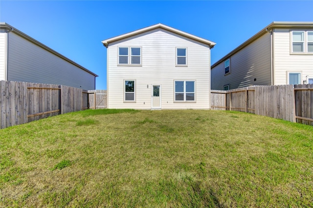 back of house with a yard