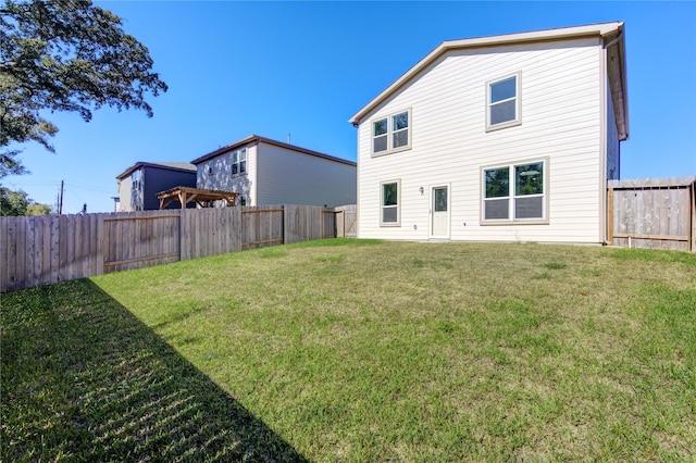 back of house featuring a yard