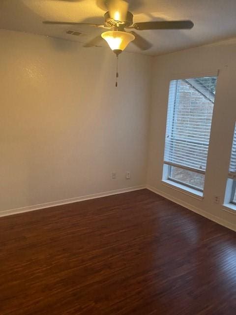 spare room with ceiling fan and dark hardwood / wood-style floors