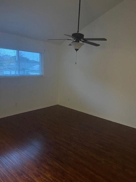 unfurnished room featuring vaulted ceiling, ceiling fan, and dark hardwood / wood-style floors