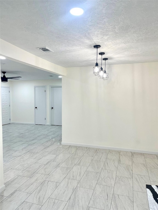 unfurnished room with a textured ceiling