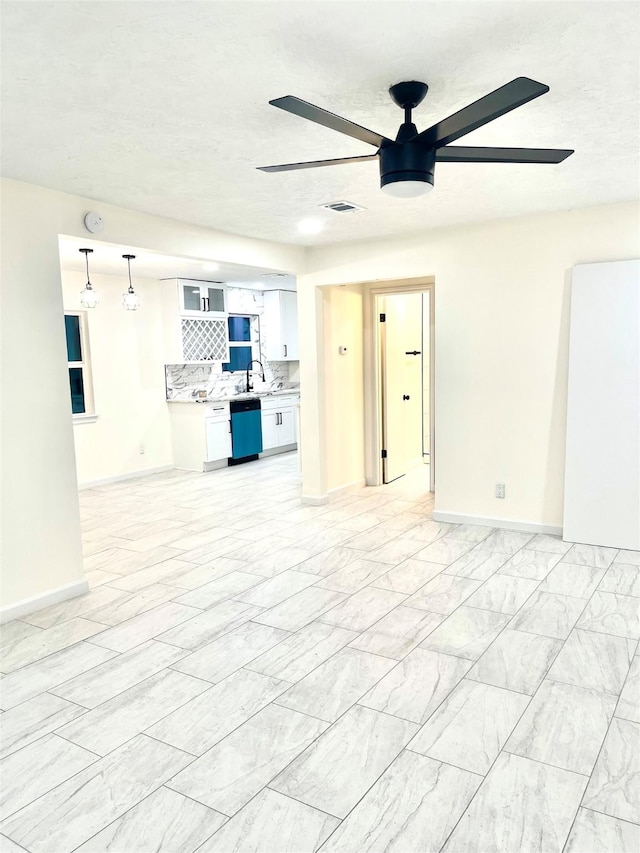 unfurnished living room with sink and ceiling fan