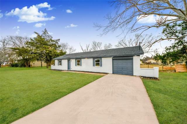 view of front facade with a garage and a front lawn