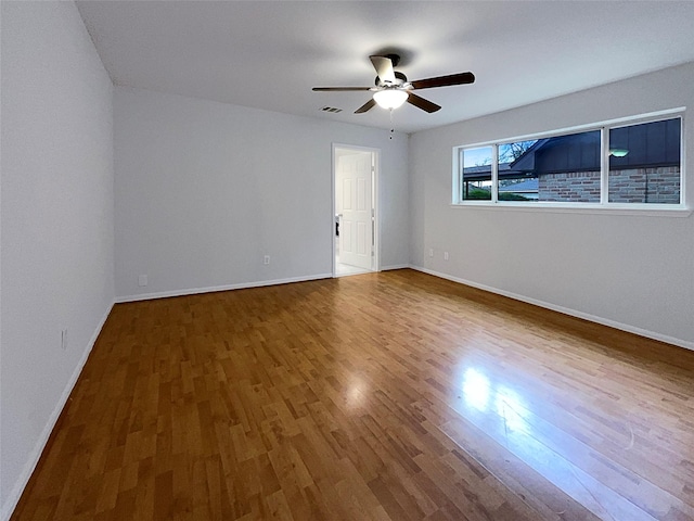 spare room with ceiling fan and hardwood / wood-style floors