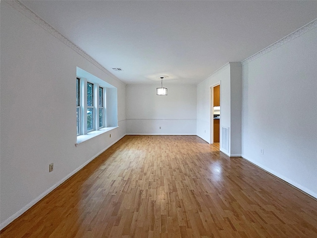 unfurnished room featuring crown molding and hardwood / wood-style flooring