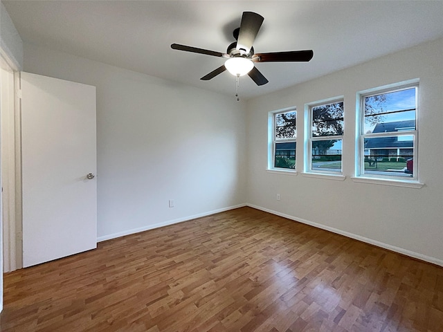 unfurnished room with ceiling fan and hardwood / wood-style floors