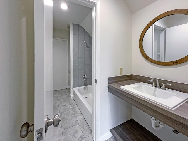 bathroom featuring tiled shower / bath and sink