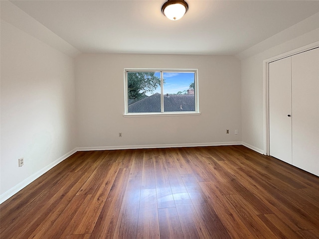 unfurnished bedroom with dark hardwood / wood-style flooring